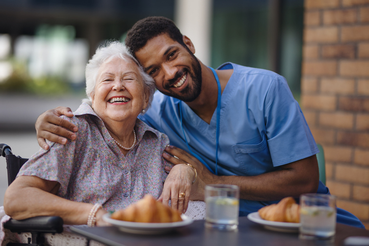 Smiling elderly woman and a nurse